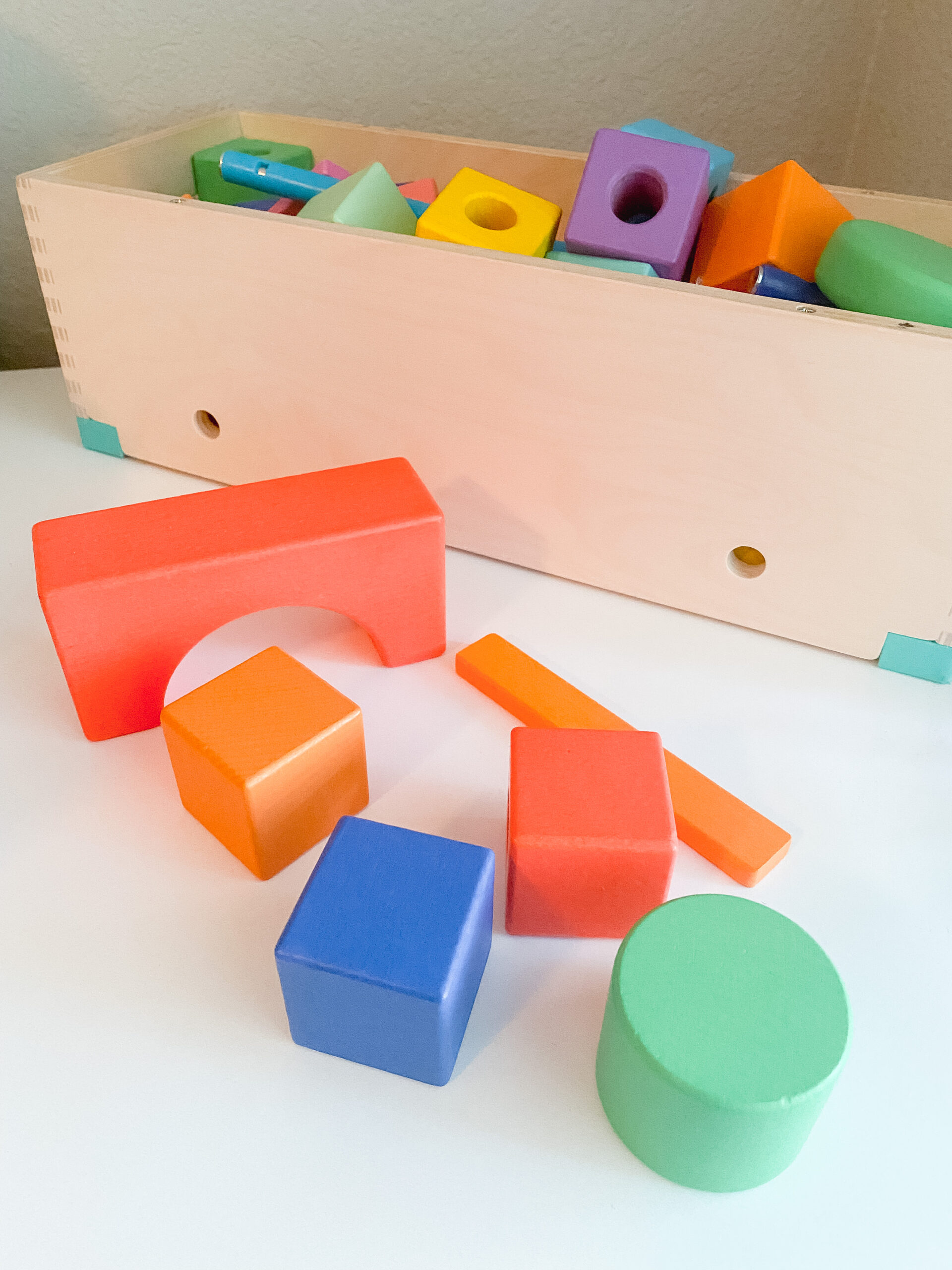 Picture features an assortment of different colors and shapes of blocks by Lovevery. The blocks are apart of Lovevery's "Block Set."